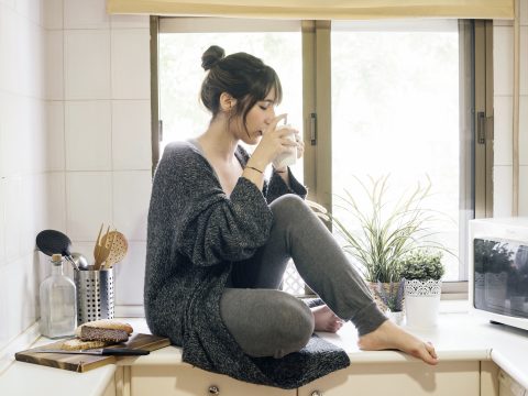 a woman sitting near the window